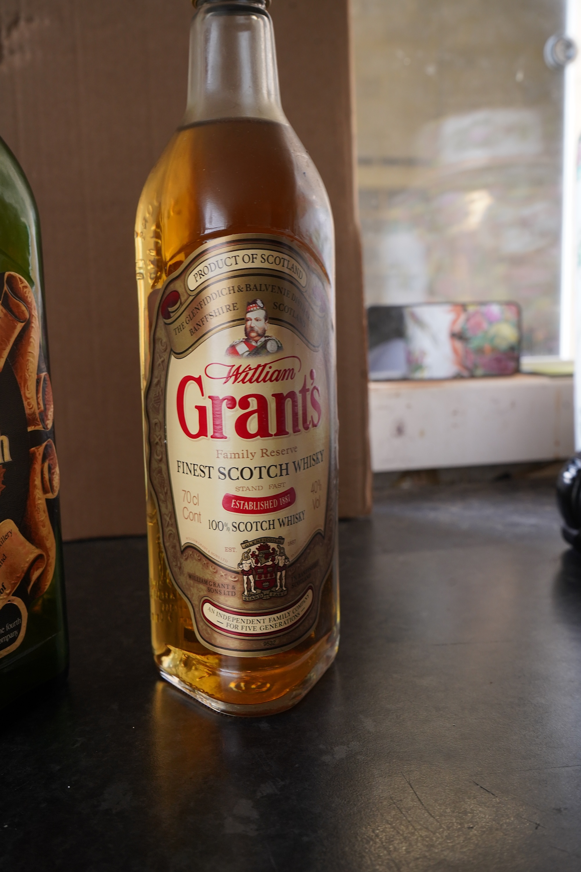 Three bottles of malt whisky: Glenmorangie, Glenfiddich and Grants